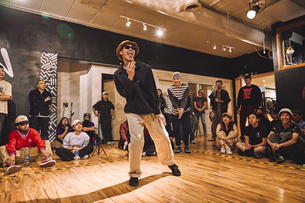 Dancer mid-groove with crowd watching